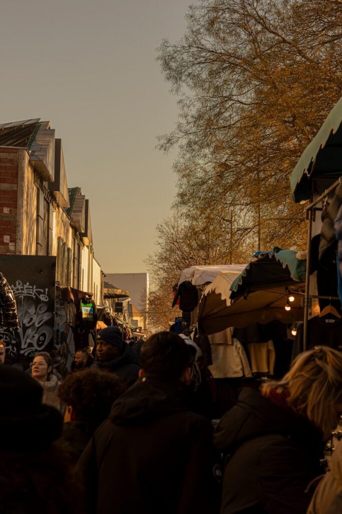 People browsing stalls at an outdoor market during the day